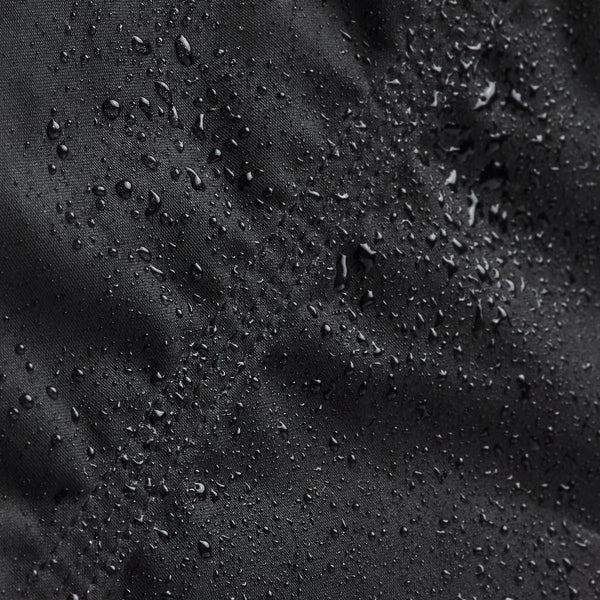 Close-up of water droplets on a black fabric surface
