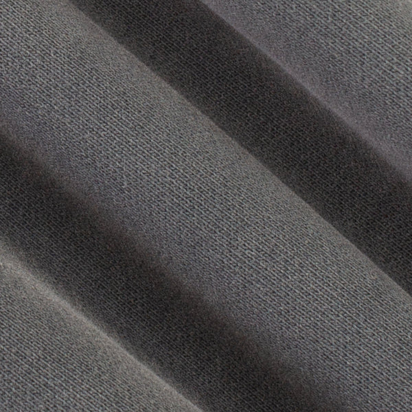 A close-up of dark gray textured fabric with soft diagonal folds showing the woven material detail.
