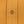 Load image into Gallery viewer, Close-up of a mustard yellow knit fabric garment with a single brown button on the front placket.
