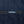 Load image into Gallery viewer, Close-up of dark indigo denim fabric with orange contrast stitching and a small rectangular Dubbleware label near the pocket.
