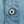 Load image into Gallery viewer, Close-up of a light blue denim garment with orange contrast stitching and a silver metal button embossed with the brand name 'CUBBLEWARE'.
