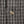 Load image into Gallery viewer, Close-up of a black and white woven fabric with a repeating geometric pattern and a single round metallic button near the center.
