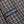 Load image into Gallery viewer, Close-up of a woven knit fabric with a dark brown and off-white textured pattern, featuring a blue embroidered label with the brand name 'OUBLEWARE' in white.

