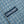 Load image into Gallery viewer, A light blue and white checkered long-sleeve button-down shirt with a Dubbleware patch label.
