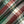 Load image into Gallery viewer, A close-up of a folded plaid fabric with a classic tartan pattern in green, red, beige, and white.
