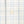 Load image into Gallery viewer, Close-up of a white or off-white fabric with a light blue windowpane plaid pattern and a single cream-colored button at the center.
