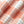 Load image into Gallery viewer, A close-up of a soft, plush fabric with a plaid pattern in peach, cream, and light blue.
