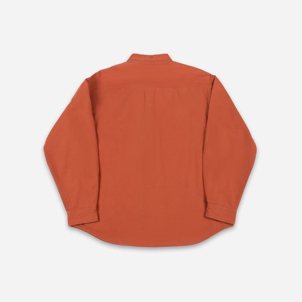 An orange long-sleeve button-down shirt shown from the back, laid flat on a light gray background.