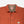 Load image into Gallery viewer, Close-up of a Doubleware work shirt in rust orange, showing the collar with a brown plaid lining, snap-button front, and a small white brand patch on the chest pocket.
