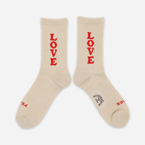 Rostersox - LOVE SOCKS - BEIGE - A pair of cream-colored crew socks with the word 'LOVE' printed vertically in red on each sock, displayed against a light gray background. - Main Front View