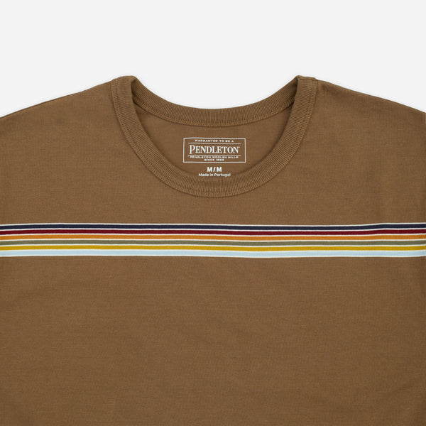 A close-up of a Pendleton brown crewneck t-shirt featuring a horizontal stripe pattern across the chest in navy, red, yellow, and white.
