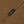 Load image into Gallery viewer, Close-up of a brown woven fabric with a small dark navy label stitched on it, printed with the brand name PENDLETON in gold lettering.
