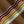 Load image into Gallery viewer, Close-up of a brown knit fabric with diagonal stripes in navy, red, orange, olive green, yellow, and light blue.
