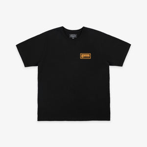 Pendleton - Patch T-Shirt - Dark Grey - A black short-sleeve crewneck t-shirt with a small orange rectangular logo patch on the left chest, displayed flat against a light gray background. - Main Front View