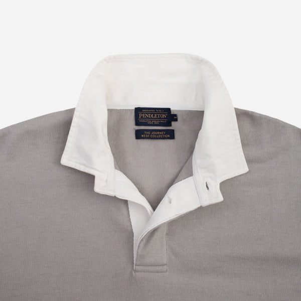 A close-up of a Pendleton wool sweater showing the collar and inner placket. The outer fabric is a textured light gray, while the inner collar and placket lining are white.