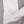 Load image into Gallery viewer, Close-up of a gray knit garment with a white collar and a round off-white button.
