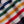 Load image into Gallery viewer, Close-up of a knitted fabric with diagonal stripes in white, green, navy, orange, and red.
