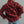 Load image into Gallery viewer, A man wearing a red and black buffalo plaid flannel shirt, shown from the back, paired with blue jeans against a plain gray studio background.
