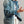 Load image into Gallery viewer, A person wearing a blue denim jacket with gold-tone buttons over a white shirt and light beige pants, photographed against a plain gray studio background.
