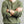 Load image into Gallery viewer, A man wearing an olive green waffle-knit long-sleeve henley shirt and blue jeans, with his arms crossed. He is wearing a brown leather strap watch on his left wrist.
