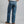 Load image into Gallery viewer, A person shown from the back wearing blue denim jeans, a white t-shirt, and brown shoes against a plain gray studio background.
